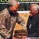 South African President Nelson Mandela (left) receives five volumes of the Truth and Reconciliation Commission final report on Oct. 29, 1998, from Archbishop Desmond Tutu, in Pretoria, South Africa. What might that report look like in America?
WALTER DHLADHLA/AFP/Getty Images